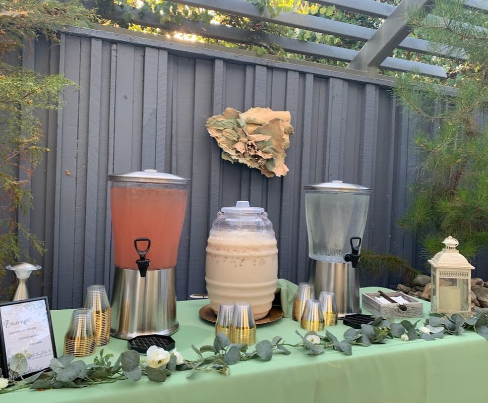 Picture of beverage station at California Botanic Garden, with strawberry lemonade, horchata, ice water